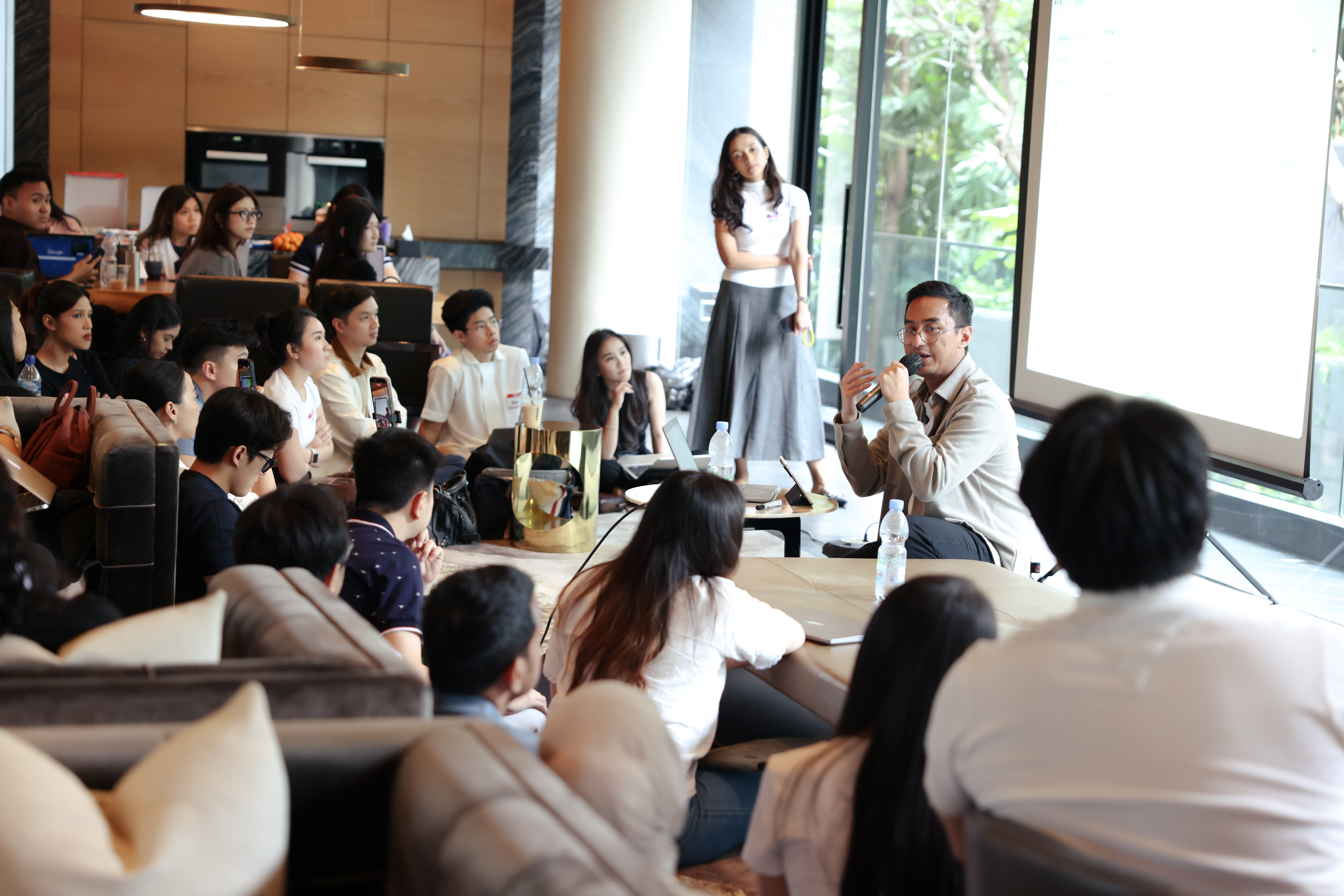 An Elevate panel session, presenter on stage with small audience